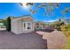 Beautiful single-story home showcasing desert landscaping with flowering bushes, large window, and covered patio at 10300 Bent Brook Pl, Las Vegas, NV 89134