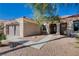 Inviting single-story home with a two-car garage, desert landscaping, stone accents and covered front entry at 10300 Bent Brook Pl, Las Vegas, NV 89134