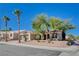 Inviting single-story home with a two-car garage, palm trees, desert landscaping, and a well-manicured front yard at 10300 Bent Brook Pl, Las Vegas, NV 89134