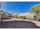 Charming single-story home featuring desert landscaping, flowering bushes and mountain views under a bright blue sky at 10300 Bent Brook Pl, Las Vegas, NV 89134