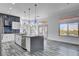 Modern kitchen with gray cabinets, stainless steel appliances, and a large island at 10300 Bent Brook Pl, Las Vegas, NV 89134