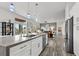 Open concept kitchen with gray countertops, stainless steel appliances, and seamless flow into living area at 10300 Bent Brook Pl, Las Vegas, NV 89134