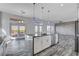 Modern kitchen with island, stainless steel appliances, and gray cabinetry at 10300 Bent Brook Pl, Las Vegas, NV 89134