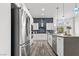 Contemporary kitchen with white cabinets, stainless steel appliances, and a large island for added prep space at 10300 Bent Brook Pl, Las Vegas, NV 89134