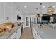 Open kitchen with white cabinets, gray countertops, and modern lighting fixtures at 11551 Earth Stone Ave, Las Vegas, NV 89138