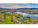 Aerial view of a luxury community with lake, golf course, and mountain views at 116 Stone Mesa Ct, Henderson, NV 89011