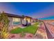 Landscaped backyard with hot tub and artificial turf at 116 Stone Mesa Ct, Henderson, NV 89011