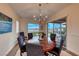 Elegant dining room with a wooden table, blue chairs, and lake views at 116 Stone Mesa Ct, Henderson, NV 89011
