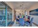 Bright dining room with wooden table and chairs, and access to a patio at 116 Stone Mesa Ct, Henderson, NV 89011