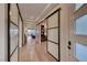 Bright hallway with glass doors and hardwood floors at 116 Stone Mesa Ct, Henderson, NV 89011