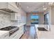 Spacious kitchen with white cabinets, herringbone backsplash and lake views at 116 Stone Mesa Ct, Henderson, NV 89011