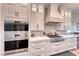 Modern kitchen features white cabinets and herringbone backsplash at 116 Stone Mesa Ct, Henderson, NV 89011