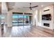Bright living room with hardwood floors, fireplace, and sliding doors leading to a scenic view at 116 Stone Mesa Ct, Henderson, NV 89011
