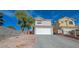 Two-story house with attached garage and desert landscaping at 1881 Citroen St, Las Vegas, NV 89142