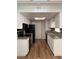 Galley kitchen with granite countertops and white cabinets at 2112 Venus Ave # A, North Las Vegas, NV 89030