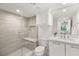 Modern bathroom with glass shower, white cabinets, and marble vanity at 2327 Alta Dr, Las Vegas, NV 89107