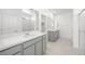 Modern bathroom features white quartz counters, dual sinks, and gray cabinets at 4540 S Pienza Ct, Pahrump, NV 89061