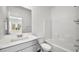 Bathroom featuring a gray vanity with white countertop, sink, toilet, and shower-tub combo at 4540 S Pienza Ct, Pahrump, NV 89061