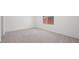 Bright bedroom with neutral carpet, white walls, and a window providing natural light at 4540 S Pienza Ct, Pahrump, NV 89061