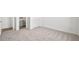 Bedroom showcasing neutral carpeting, white walls, and doorway access to other rooms and ensuite bathroom at 4540 S Pienza Ct, Pahrump, NV 89061