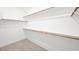 Walk-in closet featuring carpet floors, white walls, and shelving at 4540 S Pienza Ct, Pahrump, NV 89061