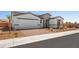 A beautiful home with a brick driveway and a two-car garage surrounded by desert landscaping at 4540 S Pienza Ct, Pahrump, NV 89061