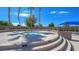 Elevated hot tub with tiered seating and a bright blue sun umbrella, perfect for relaxation at 4540 S Pienza Ct, Pahrump, NV 89061