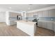Modern kitchen with quartz countertops, stainless steel appliances, and a center island at 4540 S Pienza Ct, Pahrump, NV 89061