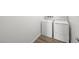Modern laundry room features white washer and dryer on wood-look tile flooring at 4540 S Pienza Ct, Pahrump, NV 89061
