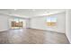 Bright and airy living room with wood-look tile flooring and sliding glass doors at 4540 S Pienza Ct, Pahrump, NV 89061
