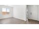 Light-filled living room with stylish wood-look flooring and fresh white walls at 4540 S Pienza Ct, Pahrump, NV 89061