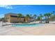 Beautiful community pool area with palm trees and a splash pad under a clear blue sky at 4540 S Pienza Ct, Pahrump, NV 89061