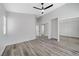 Bright bedroom with wood-look floors and mirrored closet at 524 Blackbird Knoll Ct, North Las Vegas, NV 89084