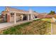 Backyard with covered patio, grassy area, and storage at 5612 Crimson Ridge Dr, Las Vegas, NV 89130