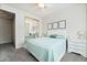 Bright bedroom with light teal bedding, mirrored closet doors, and a white dresser at 5684 Benevento Ct, Las Vegas, NV 89141