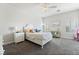 Charming bedroom with white bed frame, gray carpet, and a built-in desk at 5684 Benevento Ct, Las Vegas, NV 89141