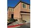 Two-story house with attached garage and light brown exterior at 616 Taliput Palm Pl, Henderson, NV 89011