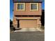 Two-story house with attached garage and light brown exterior at 616 Taliput Palm Pl, Henderson, NV 89011