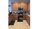 Kitchen with light brown cabinets, granite countertops, and stainless steel appliances at 616 Taliput Palm Pl, Henderson, NV 89011