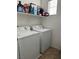 Convenient laundry room complete with washer, dryer, and storage shelf at 616 Taliput Palm Pl, Henderson, NV 89011