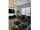 Living room with gray couches, large TV, and coffee table at 616 Taliput Palm Pl, Henderson, NV 89011