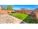 Artificial turf backyard with brick pavers and hot tub at 7528 Abby View St, Las Vegas, NV 89166