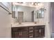 Double vanity bathroom with dark brown cabinets at 7528 Abby View St, Las Vegas, NV 89166