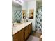 Double vanity bathroom with wood cabinets and decorative wall art at 87 Japonica Ave, Las Vegas, NV 89183