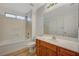 Bright bathroom with a tub and shower combination and a wood vanity with a white countertop at 9204 Weeping Hollow Ave, Las Vegas, NV 89178