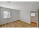 Neutral bedroom featuring wood-look floors and a view into hallway at 9204 Weeping Hollow Ave, Las Vegas, NV 89178