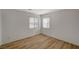 Bedroom with wood-look flooring and natural light from two windows at 9204 Weeping Hollow Ave, Las Vegas, NV 89178