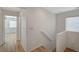 Upstairs hallway with white walls, wood-look floors, and plenty of natural light at 9204 Weeping Hollow Ave, Las Vegas, NV 89178