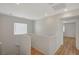 Hallway with stairs, white walls, wood-look floors, and lots of natural light at 9204 Weeping Hollow Ave, Las Vegas, NV 89178