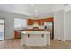 The kitchen features wood cabinets, stainless steel appliances, a center island, and access to the backyard at 9204 Weeping Hollow Ave, Las Vegas, NV 89178